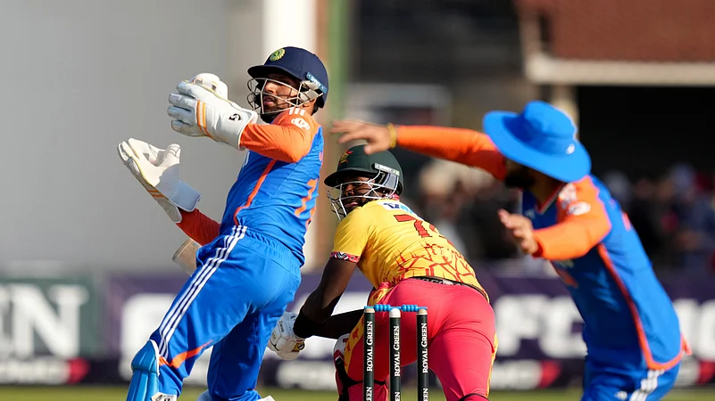 Zimbabwe batsman Luke Jongwe, centre, in action during the T20 cricket between Zimbabwe and India at Harare Sports Club, Harare. AP Photo
