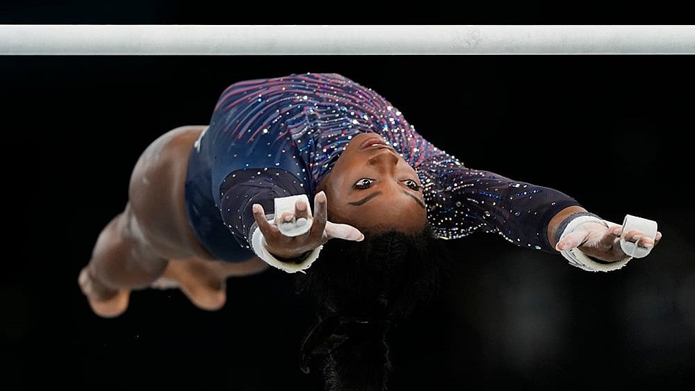 | Photo: AP/Francisco Seco : Simone Biles practices the uneven bars