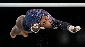 | Photo: AP/Francisco Seco : Simone Biles practices the uneven bars