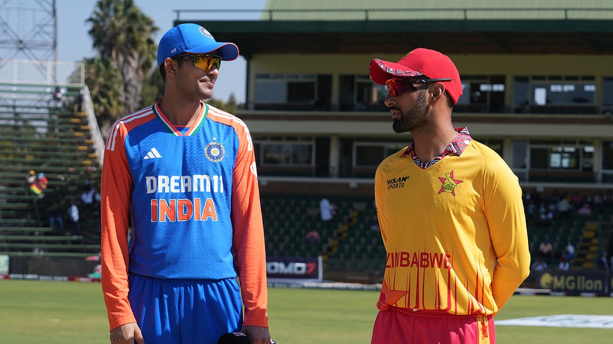 AP Photo/Tsvangirayi Mukwazhi : Indian captain Shubman Gill, left, and Zimbabwe captain Sikandar Raza on the pitch before the coin toss on the second day of the T20 cricket between Zimbabwe and India at Harare Sports Club, Harare.