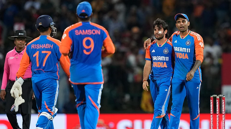 India's Ravi Bishnoi celebrates the wicket of Sri Lanka's Wanidu Hasaranga with teammates during the second Twenty20 cricket match between Sri Lanka and India in Pallekele, Sri Lanka. - AP Photo/Eranga Jayawardena
