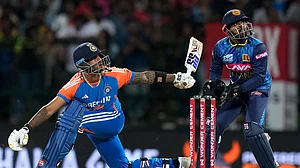 AP Photo/Eranga Jayawardena : India's captain Suryakumar Yadav watches his shot during the second Twenty20 cricket match between Sri Lanka and India in Pallekele, Sri Lanka.