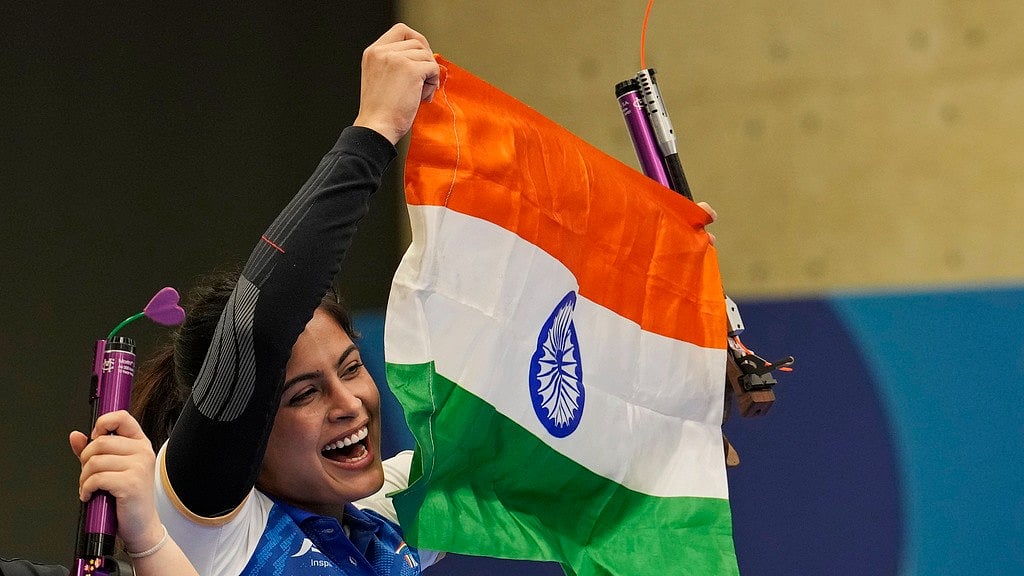 Manu Bhaker celebrates with the tri-colour after winning India its first medal at Paris Olympic Games 2024. - AP/Manish Swarup