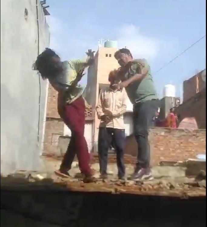 Man slaps woman who falls from a roof in Delhi