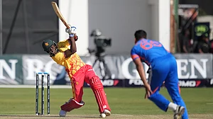 AP Photo/Tsvangirayi Mukwazhi : Zimbabwe's batsman Clive Madande, left, plays a shot during the T20 cricket match against India at Harare Sports Club.