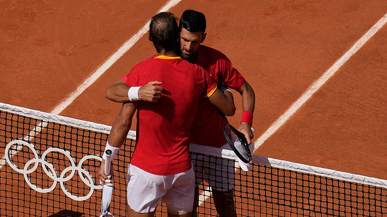Serbia's Novak Djokovic, right, hugs Spain's Rafael Nadal after their men's singles second-round match at the Roland Garros Stadium at the 2024 Summer Olympics. - AP Photo/Manu Fernandez