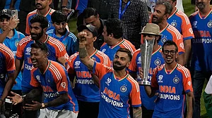 Photo: AP/Rafiq Maqbool : The triumphant Indian men's cricket team with the T20 World Cup trophy at Wankhede Stadium on Thursday (July 4).