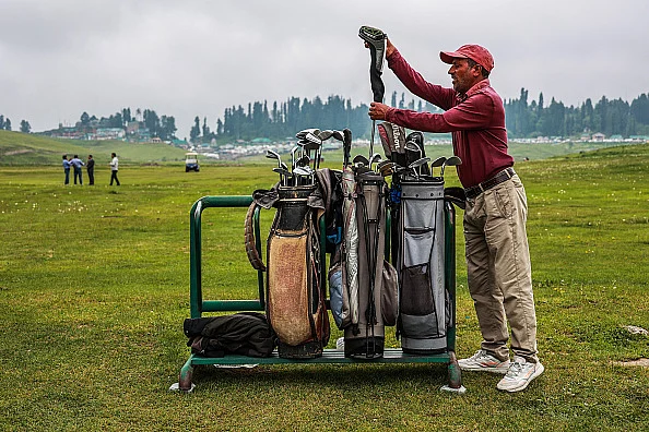 An employee of the Golf Course is checking golf equipment at Famous Ski Resort in Gulmarg