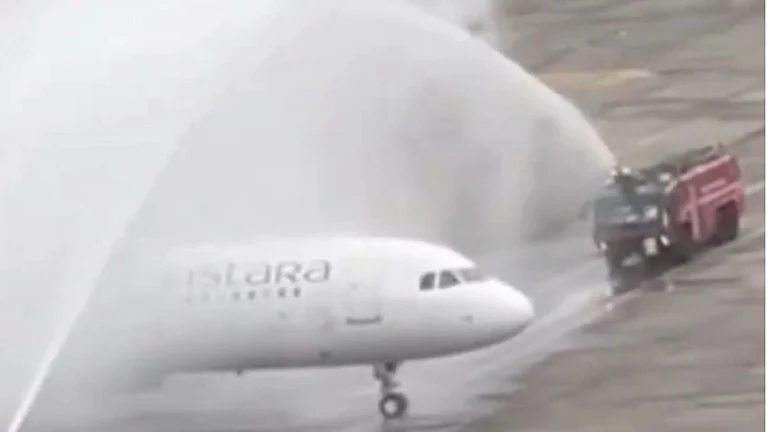 Screengrab of the water cannon salute given to the airplane ferrying the Indian cricket team. - null