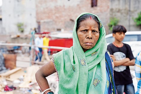 Savitri Devi works at a dump yard near Geeta Colony