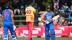 AP Photo/Tsvangirayi Mukwazhi : Zimbabwe bowler Blessing Muzarabani, centre, reacts after taking a wicket during the T20 cricket match between Zimbabwe and India at the Harare Sports Club, in Harare.