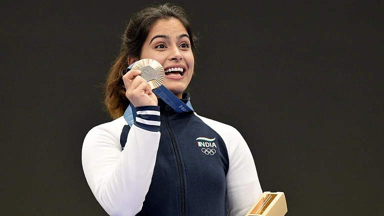 Manu Bhaker of India poses with her bronze medal at the Paris Olympic Games 2024. - X/pinarayivijayan