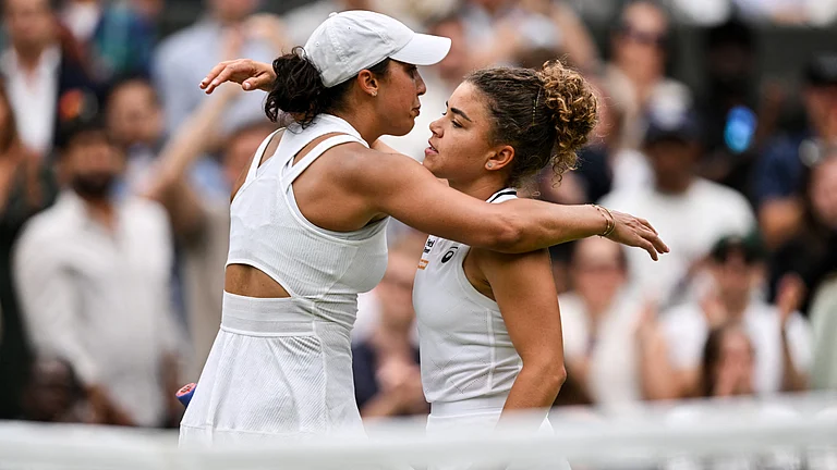 Madison Keys and Jasmine Paolini embrace after the American retires hurt at Wimbledon on Sunday. - null