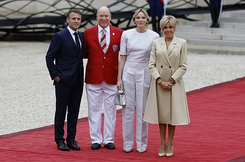 French President Emmanuel Macron and his wife Brigitte Macron, right, welcome Prince Albert II of Monaco and Princess Charlene of Monaco ahead of the opening ceremony.