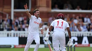 Steven Paston/PA via AP : England's James Anderson celebrates bowling out West Indies' Kraigg Brathwaite on day two of the first Test match between England and West Indies at Lord's Cricket Ground, London.