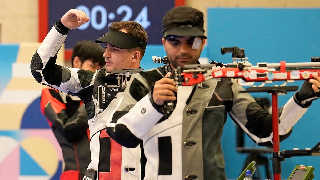 AP/Manish Swarup : Croatia's Miran Maricic, center, celebrates after securing the third place as India's Arjun Babuta, right, is knocked out of the 10m air rifle men's final.