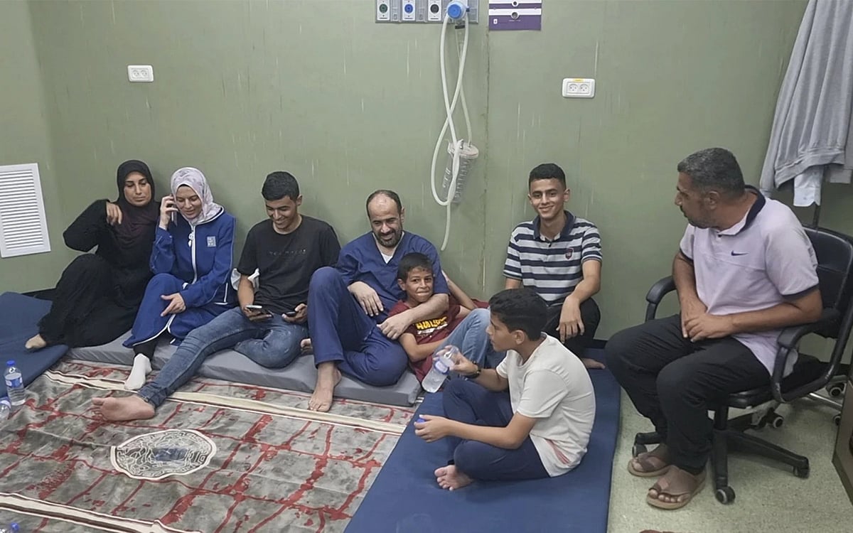 This image shows Mohammed Abu Selmia, director of Gaza's al-Shifa hospital, with his family after release | - AP