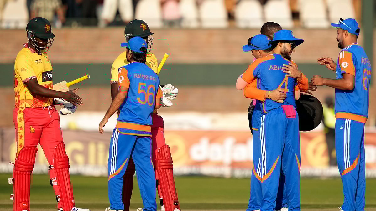 AP Photo/Tsvangirayi Mukwazhi : Players shake hands at the end of the T20 cricket between Zimbabwe and India at Harare Sports Club, Harare.