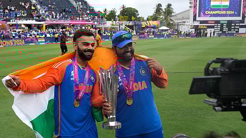 India's Virat Kohli, left, and captain Rohit Sharma pose with the winners trophy after defeating South Africa in the ICC Men's T20 World Cup final cricket match at Kensington Oval in Bridgetown, Barbados, Saturday, June 29, 2024.