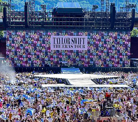 Fans crowded outside an Eras Tour concert venue.