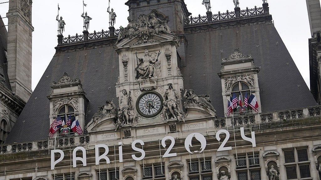 The logo of the Paris 2024 Olympic Games hangs from the facade of the Paris city hall, days ahead of the opening ceremony. - AP