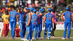 AP Photo/Tsvangirayi Mukwazhi : Indian players are seen on the pitch during the T20 cricket between Zimbabwe and India at Harare Sports Club.