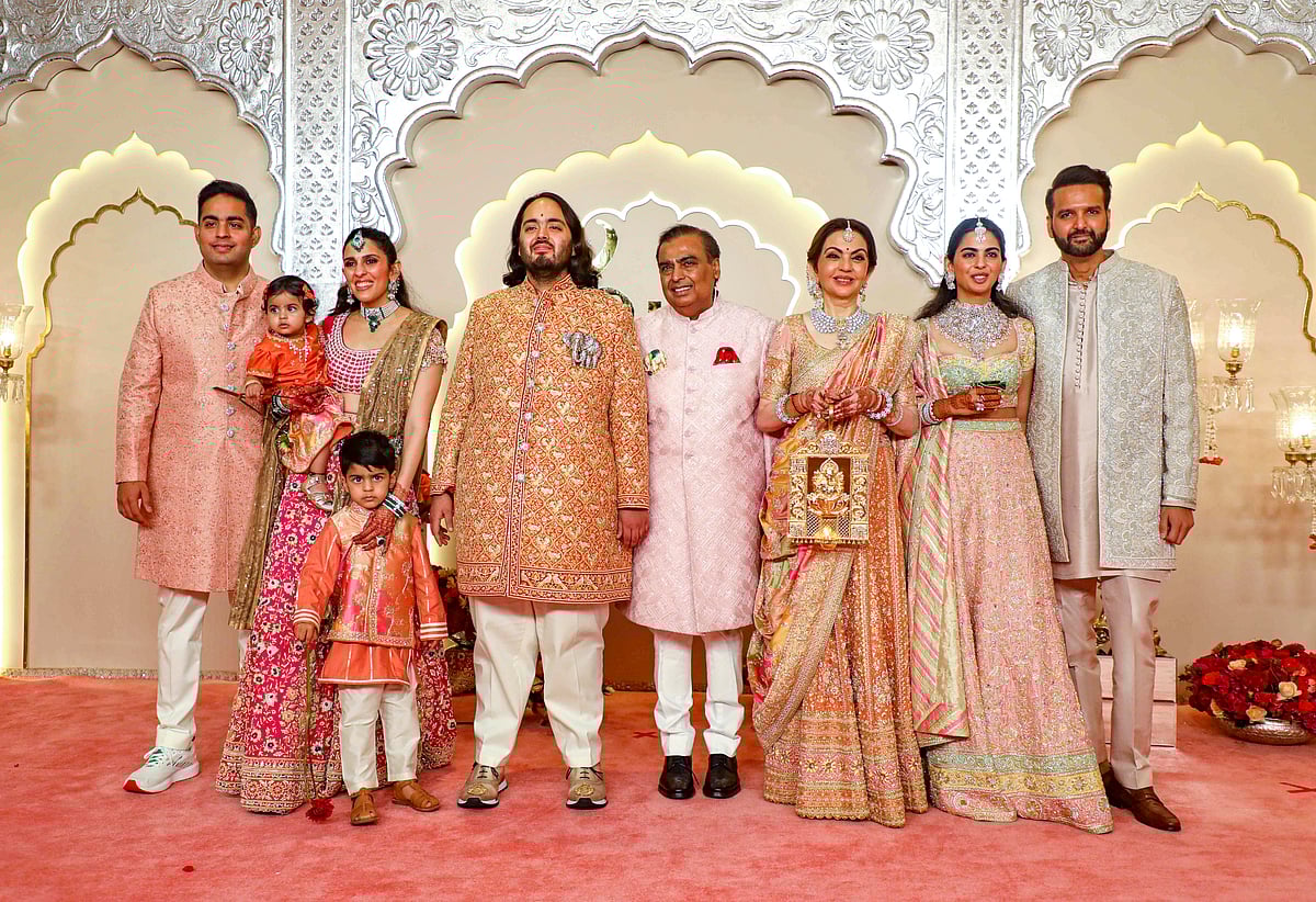 - (PTI Photo) : Reliance Industries Chairman Mukesh Ambani with wife Nita Ambani, sons Akash and Anant Ambani, daughter-in-law Shloka Mehta Ambani, daughter Isha Ambani and son-in-law Anand Piramal, poses for pictures upon their arrival for Anant and Radhika Merchant's wedding, at Jio World Convention Centre, in Mumbai, Friday, July 12, 2024.