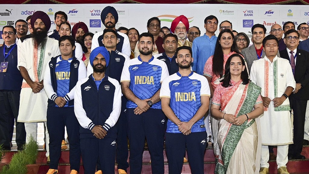 Photo: Press Information Bureau via AP : Athletes model India's ceremonial and playing uniforms for Paris Olympic Games 2024.