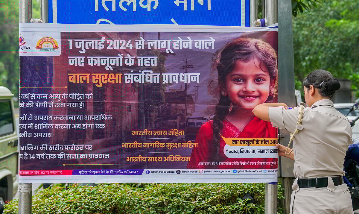 (PTI Photo) : A poster depicting the implementation of three new criminal laws -- Bharatiya Nyaya Sanhita, Bharatiya Nagarik Suraksha Sanhita and the Bharatiya Sakshya Adhiniyam -- being put by Delhi Police to raise awareness, in New Delhi, Monday, July 1, 2024. 
