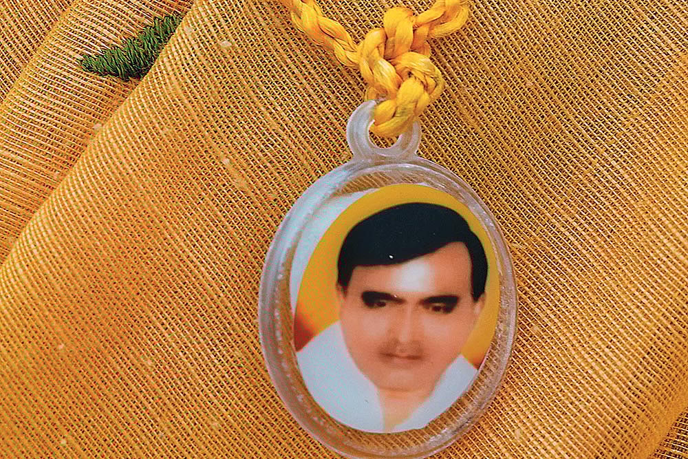 Photo: Suresh K. Pandey : A devotee sports a pendant with Baba Bhole Nath’s face on it in Mainpuri, Uttar Pradesh, sold for Rs 10 each