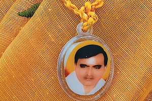 Photo: Suresh K. Pandey : A devotee sports a pendant with Baba Bhole Nath’s face on it in Mainpuri, Uttar Pradesh, sold for Rs 10 each