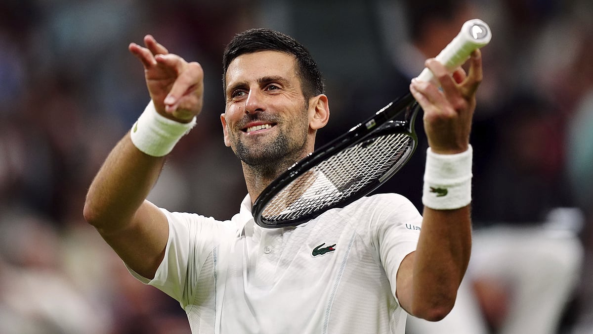 Mike Egerton/PA via AP : Novak Djokovic of Serbia pretends to play a violin after defeating Holger Rune of Denmark in their fourth-round match at Wimbledon 2024 in London, Monday, July 8, 2024.