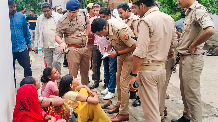 Police communicating with a Hathras stampede victim's family - PTI