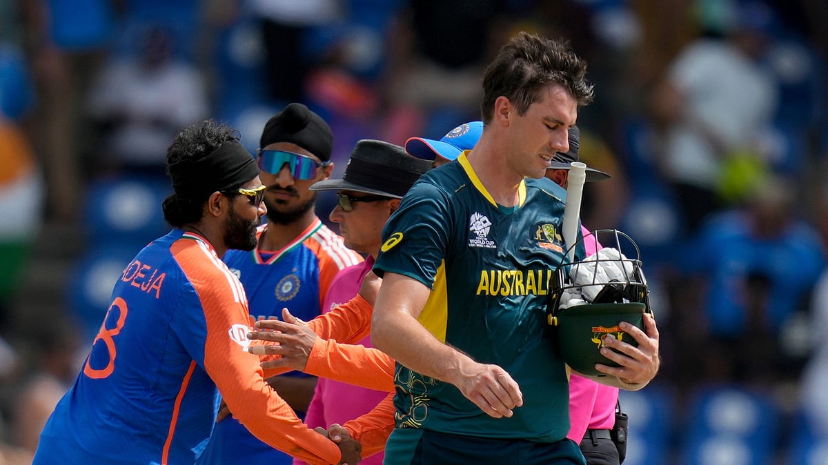 AP Photo/Ramon Espinosa : Australia's Pat Cummins walks off the field after his side lost by 24 runs against India in an ICC Men's T20 World Cup cricket match at Darren Sammy National Cricket Stadium in Gros Islet, Saint Lucia.