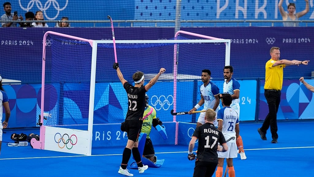 Germany's Marco Miltkau, left, celebrates after scoring his side's third goal during the men's semifinal field hockey match between Germany and India at the Yves-du-Manoir Stadium during the 2024 Summer Olympics, Tuesday, Aug. 6, 2024, in Colombes, France. - AP/Aijaz Rahi