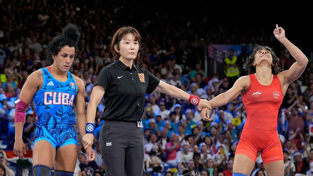 AP/Eugene Hoshiko : India's Vinesh Phogat, right, celebrates after defeating Cuba's Yusneylys Guzman compete during their women's freestyle 50kg wrestling semifinal match, at Champ-de-Mars Arena, during the 2024 Summer Olympics, Tuesday, Aug. 6, 2024, in Paris, France.