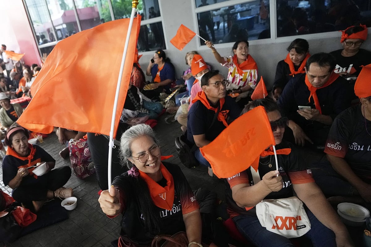 Supporters of Move Forward Party wave the party's flag at the party headquarters in Bangkok | - AP