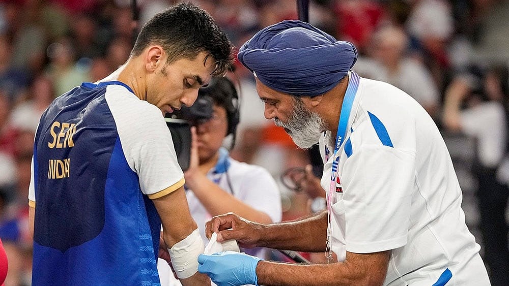 Lakshya Sen being given medical assistance during his men's singles bronze medal badminton match - | Photo: PTI/Ravi Choudhary