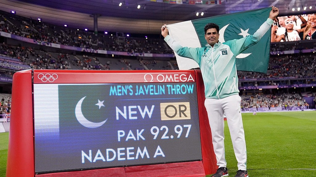 AP/Matthias Schrader : Arshad Nadeem of Pakistan celebrates after winning the men's javelin throw final at the Paris Olympics.