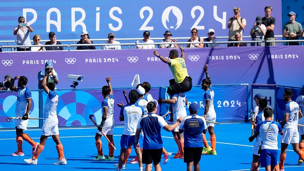 India's goalkeeper Parattu Reveendran Sreejesh, in yellow jersey, is carried on the shoulders by captain Harmanpreet Singh as India's players take a victory lap after winning the men's bronze medal field hockey match against Spain at the Yves-du-Manoir Stadium during the 2024 Summer Olympics, Thursday, Aug. 8, 2024, in Colombes, France. - AP/Aijaz Rahi