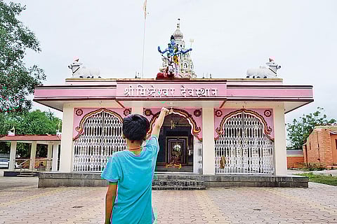 Satish Shinge points at the temple where Dalits are barred