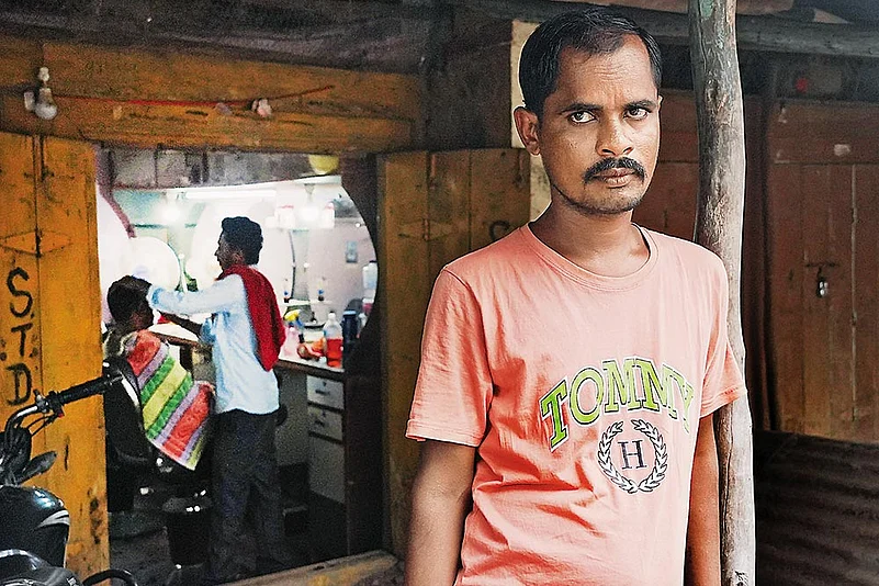 Tukaram standing at a distance from the salon