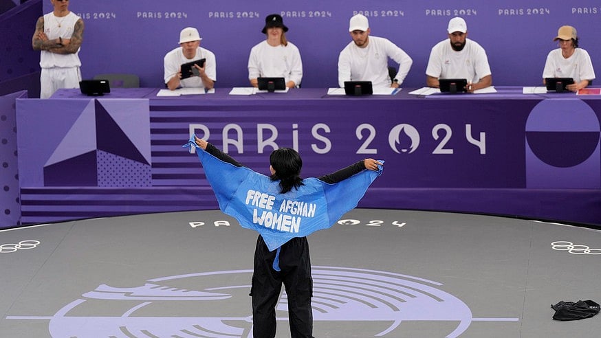 AP : Refugee Team's Manizha Talash, known as Talash, wears a cape which reads "free Afghan women" as she competes during the B-Girls Pre-Qualifier Battle at the breaking competition at La Concorde Urban Park at the 2024 Summer Olympics, Friday, Aug. 9, 2024, in Paris, France.