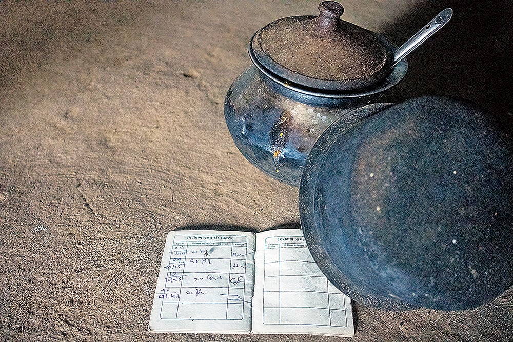 Photo: Animikh Chakrabarty : Left behind Mamta: BPL card and cooking vessels at Reshmi Bai’s home.