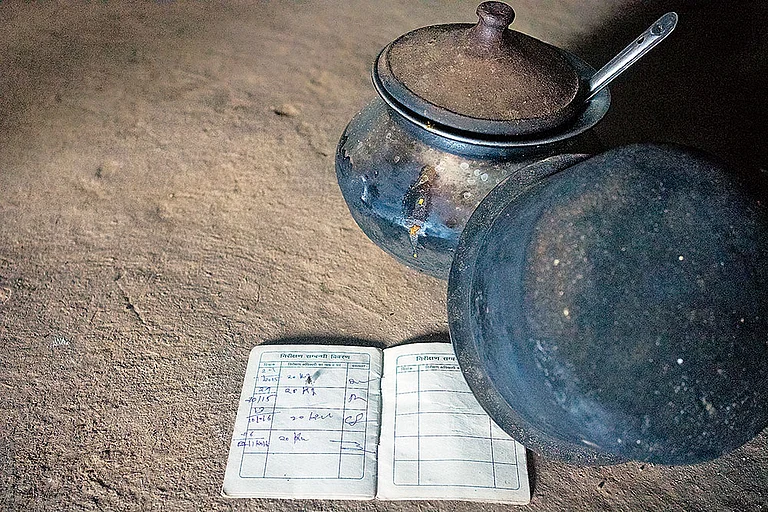 Left behind Mamta: BPL card and cooking vessels at Reshmi Bai’s home. - Photo: Animikh Chakrabarty