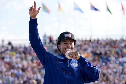 Nyjah Huston, of the United States, poses after winning the bronze medal in the men's skateboard street final at the 2024 Summer Olympics, Monday, July 29, 2024, in Paris, France.
