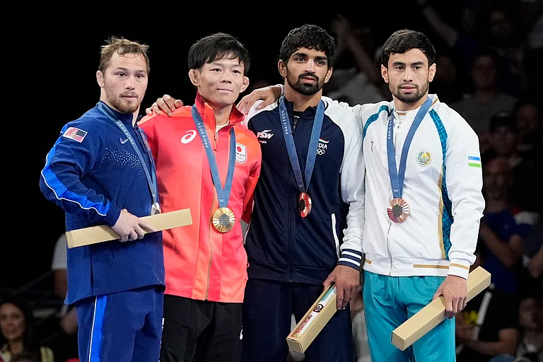 Medalists, from left, Spencer Richard Lee, of the United State, silver, Japan's Rei Higuchi, gold, India's Aman Sehrawat, Uzbekistan's Gulomjon Abdullaev, bronze, pose on the podium during the medal ceremony for men's freestyle 57kg wrestling, at Champ-de-Mars Arena, during the 2024 Summer Olympics, Friday, Aug. 9, 2024, in Paris, France. - Eugene Hoshiko