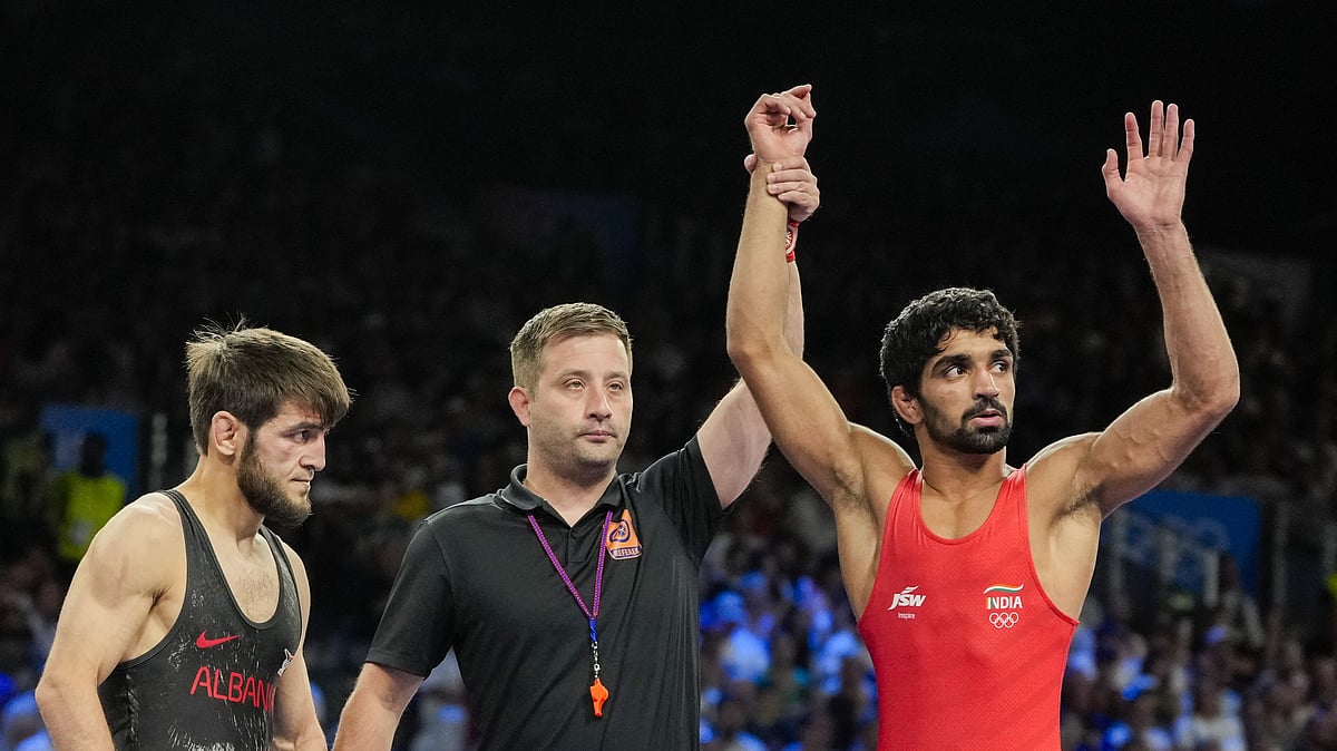 Photo: PTI : Aman Sehrawat (right) reacts after winning the men's freestyle 57kg wrestling quarter-final bout against Albania's Zelimkhan Abakarov at the Paris Olympics. 