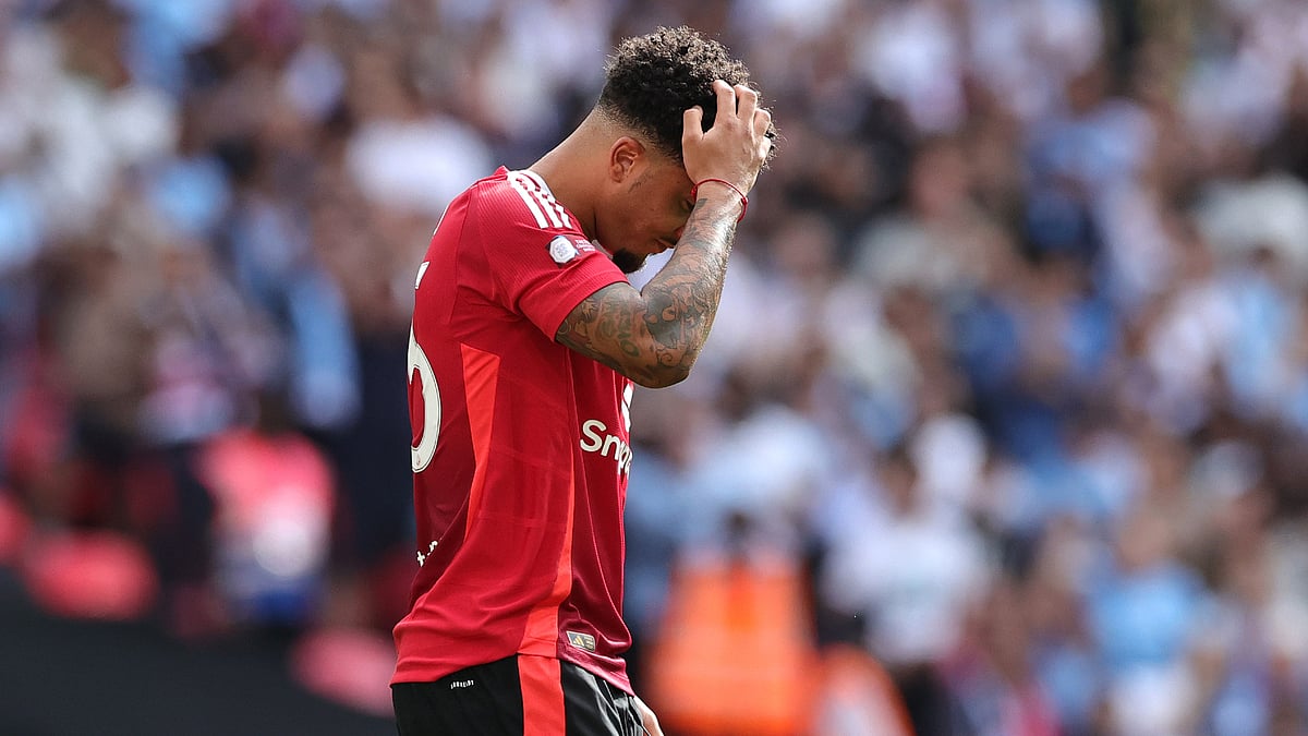 Jadon Sancho reacts after seeing his penalty saved by Ederson.