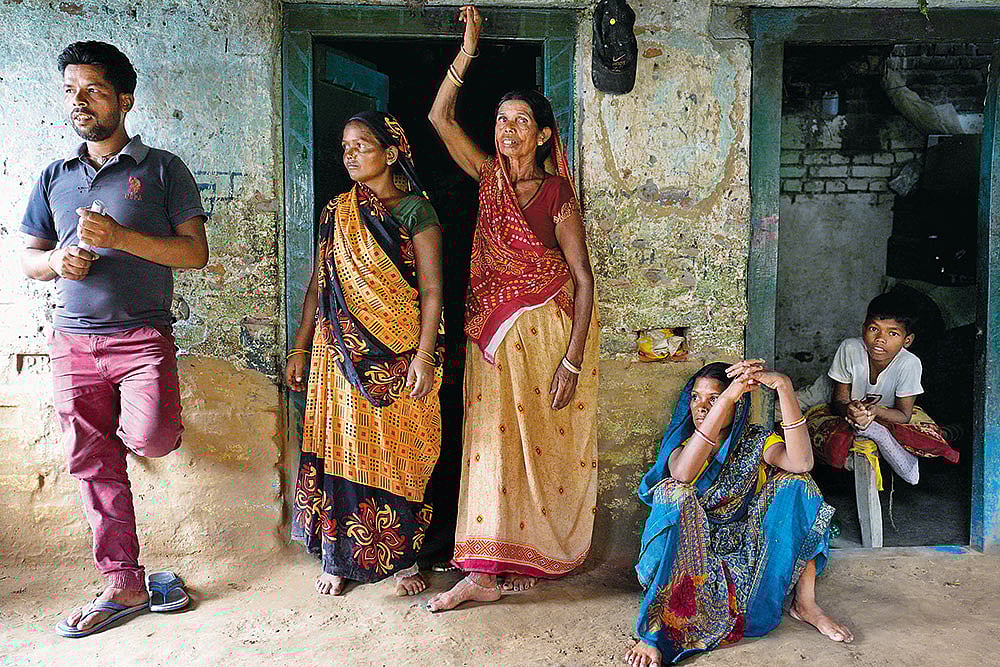 Photograph: Suresh K. Pandey : The Cycle of Misery:  
Mithilesh Rajbanshi with his wife, mother and sister-in-law at their home in Bargaon village in Gaya, Bihar. The three worked as bonded labourers for years   